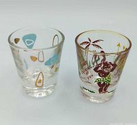 Front view of both shot glasses showing primary designs