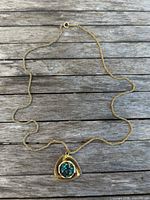 Full view of necklace laid flat showing chain and pendant