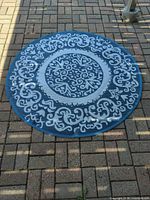 Full view of rug showing blue-dominant side and ornamental pattern