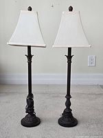 Front view of both matching dark bronze table lamps with off-white square shades