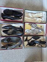 Overview of six shoe pairs in boxes