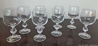 Eight crystal wine glasses arranged on table