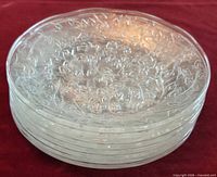 Stack of clear glass plates showing embossed rims