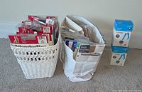 Overall view showing wicker basket and bag filled with packaged pantyhose plus two George knee-high boxes