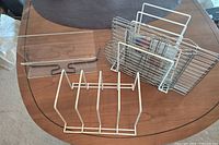 Group view of acrylic stand, white divider, frame with five chrome racks