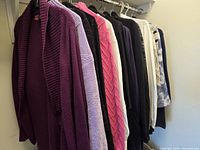 Rack of assorted sweaters and cardigans on hangers