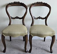 Full view of both balloon-back chairs showing overall design and upholstery