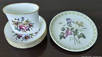 Overall view showing Camilla vase on stack of saucers beside Bournemouth plate