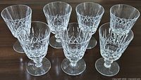 Front view of all seven cut crystal wine glasses