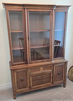 Full view of china cabinet with hutch showing glass doors and overall design
