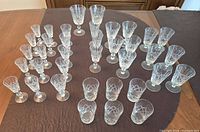 All 37 crystal glasses arranged on table showing three distinct styles