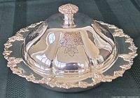 Assembled serving dish with lid showing grape border and floral engraving