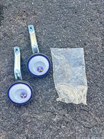 Full view of both training wheels with brackets and hardware bag