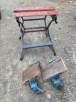Overall view of Black & Decker Workmate folding workbench and two Workhorse platform brackets laid on ground