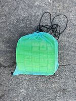 Mesh drawstring bag containing kit
