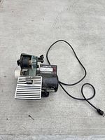 Full view of Delta belt sander with cord and work rest