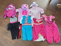 All seven costumes laid out on floor