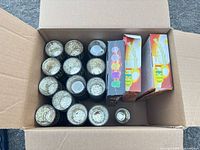 Open box showing stacked mercury glass votive holders and boxed LED candles