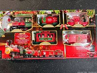 front of boxed North Pole Express 33-piece battery train set showing contents