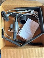 Boxed kit showing main components including vacuum hose, adapter, cable brush and instruction sheet