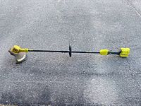 Full view of Ryobi 18V cordless trimmer showing straight shaft and guard