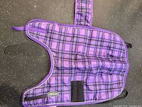 Dog coat laid flat interior showing pattern, straps visible