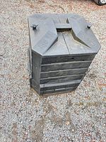 Angled view of full SoilSaver plastic composter showing top handle and side panels