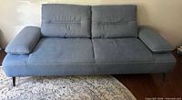 Front view of blue sleeper sofa showing overall design