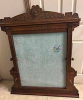 Full view of bulletin board showing wood frame and blue fabric panel