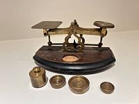 Scale front with four brass weights
