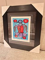 Framed Christian Morrisseau Thunderbird lithograph with protective corner covers