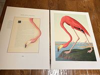 Both lithographs side by side on wooden surface