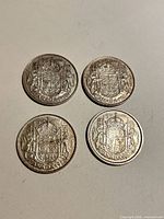 Four Canadian 50 cent coins reverse side