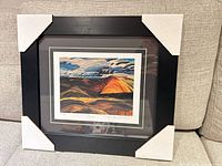 Full view of framed lithograph with protective corner covers