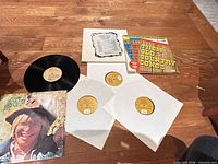 Overview of all records, sleeves and inserts on floor
