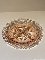 Overhead view of pink divided dish showing diamond rim and four compartments