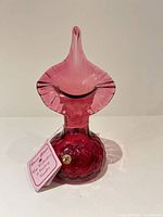 Front view of cranberry ruby red handblown Rossi Glass vase with tag and label visible