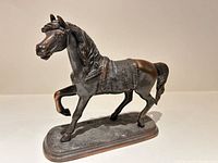 Front left view of bronze horse figurine on base