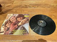 Front cover beside vinyl record