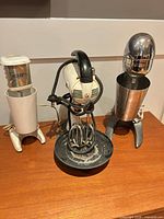 Three vintage mixers on table