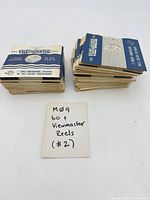 Two stacked piles of View-Master reels with hand-written card noting quantity