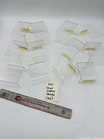 All 12 clear acrylic risers with ruler for scale