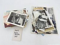 Two stacks of assorted vintage photographs