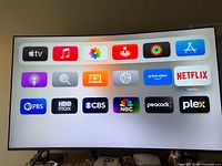 Front view of Samsung curved TV powered on showing app interface