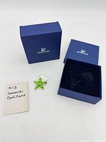 Figurine, closed and open Swarovski boxes, note with model name