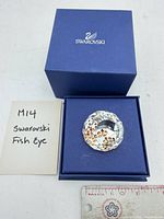 Crystal paperweight in open box next to note card