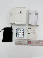 All components: crystal tulip figurine, pouch, box, ruler for scale