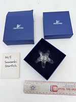 Starfish in open box with additional box, note and ruler visible