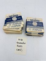 Two stacks of sleeved View-Master reels with hand-written note indicating 60 total