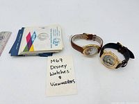 Group shot of both wristwatches and stack of View-Master reels